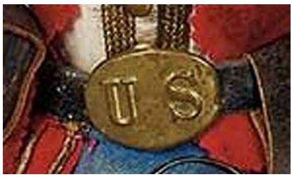 Close-up of the vivandière doll’s oval “US” belt plate